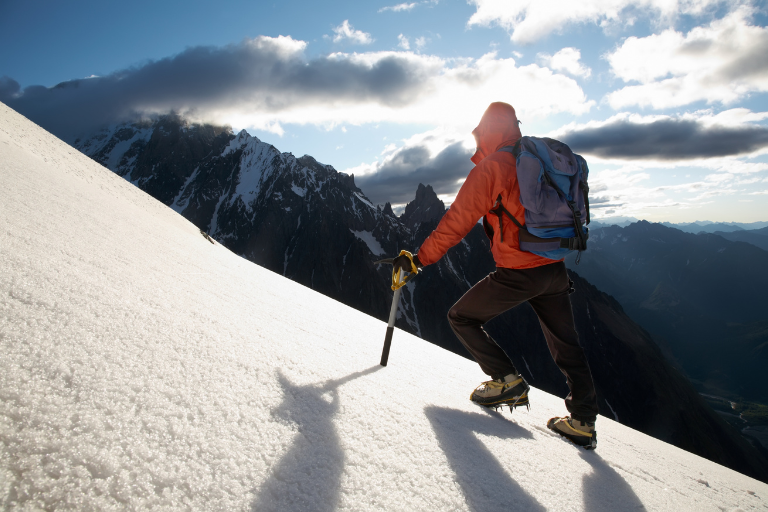 Climber on the summit of a high mountain